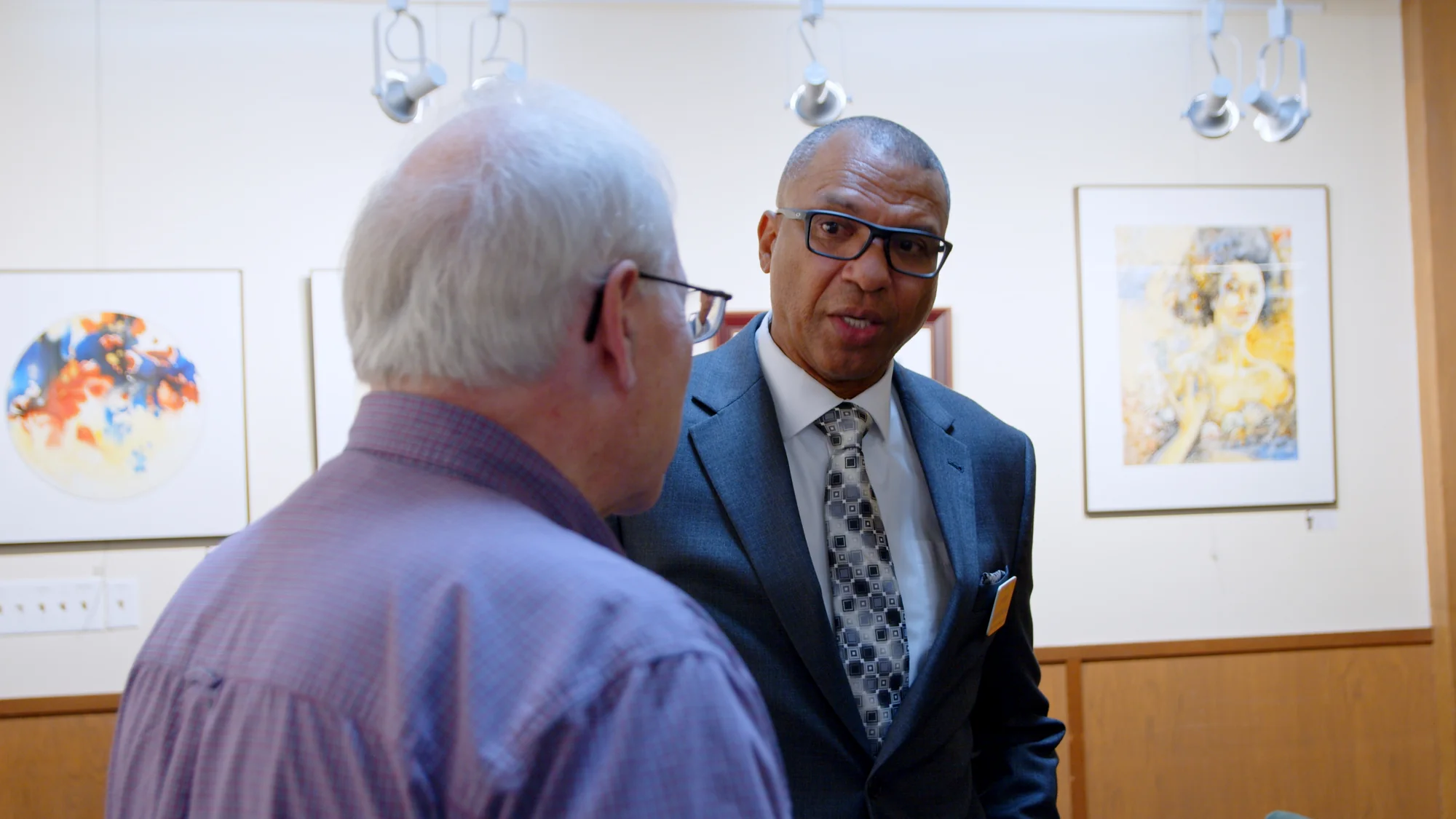 James Armstrong speaking with a community member at a gathering