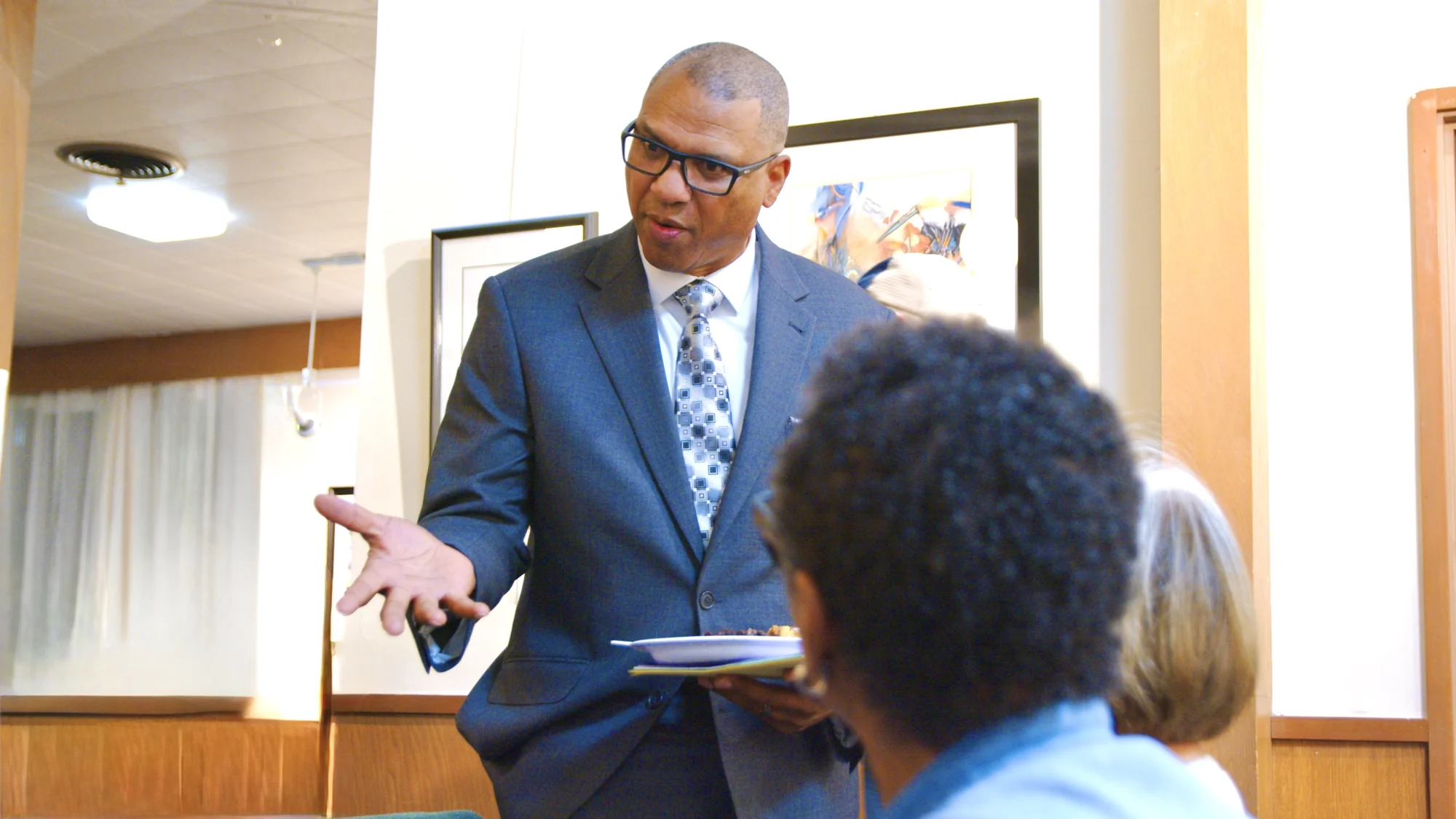 James Armstrong talking with attendees at a community gathering